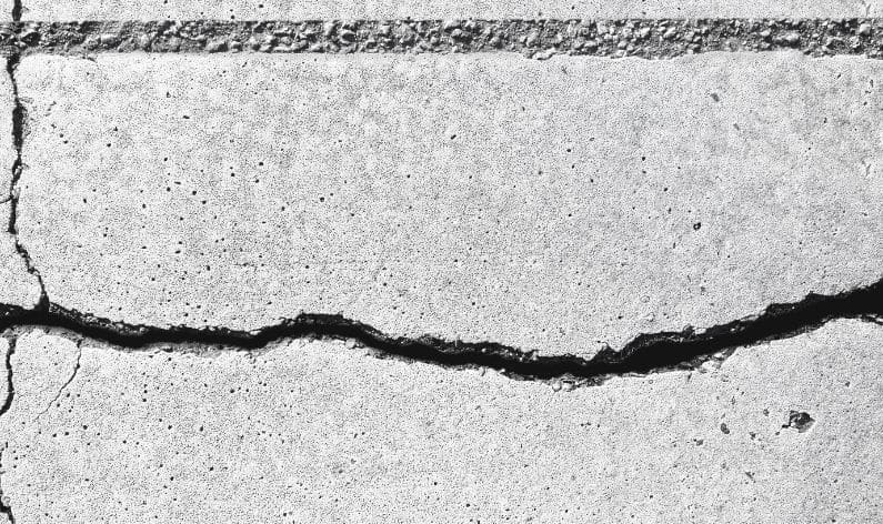 closeup of a horizontal crack in the edge of a concrete slab