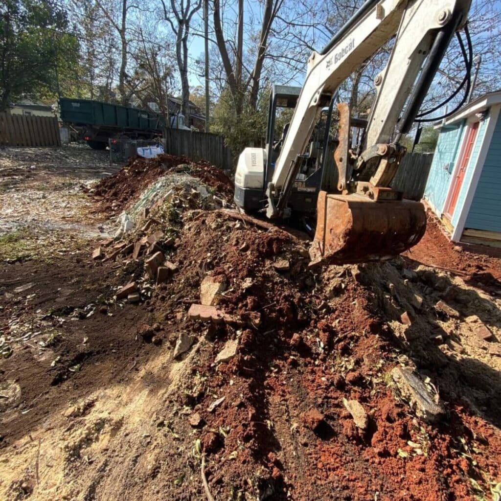 A bulldozer digging through a pile of dirt