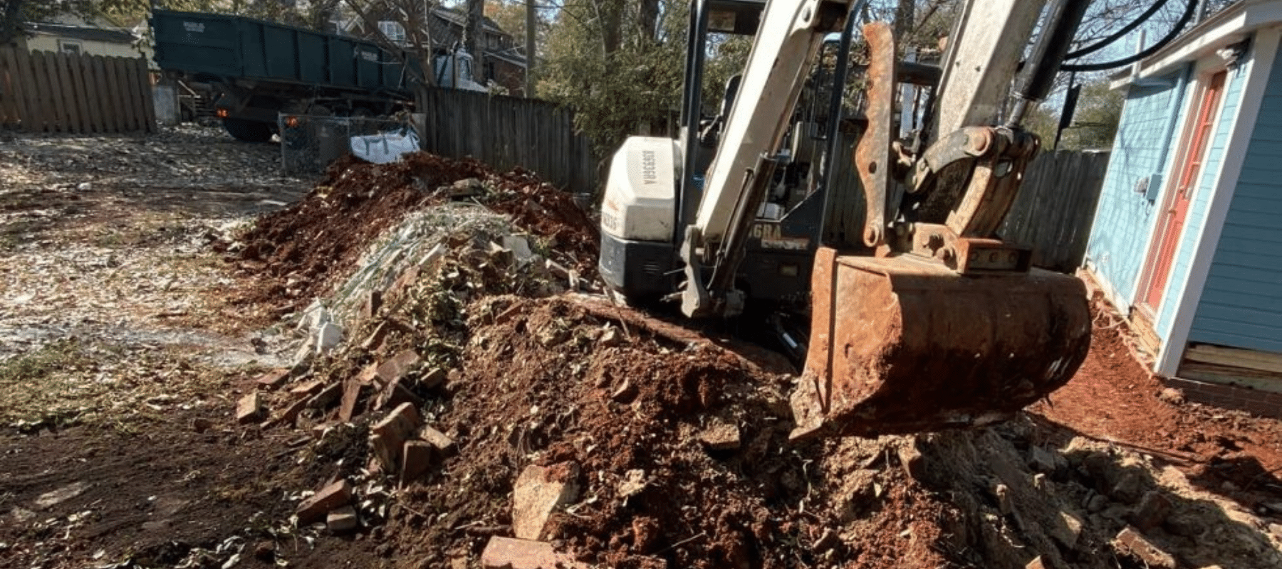 A bulldozer digging through a pile of dirt
