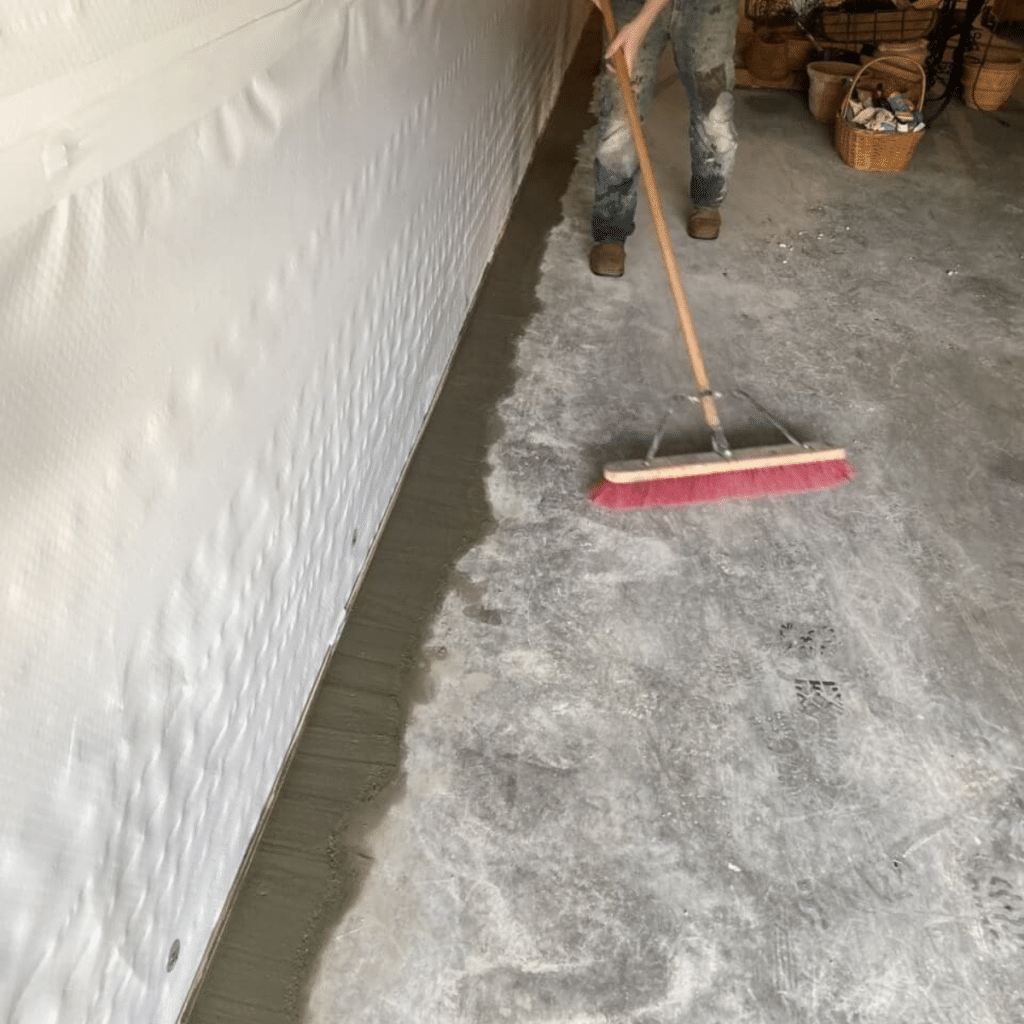 foundation repair expert sweeping concrete floor