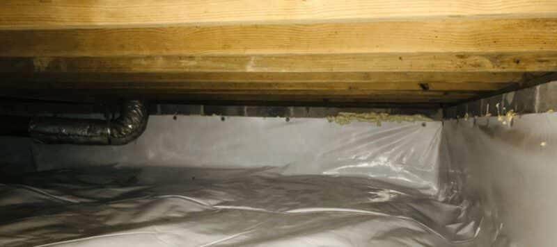 crawl space that is covered with white tarp