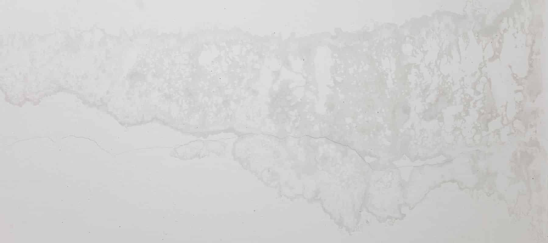 A white wall with water seeping through it.