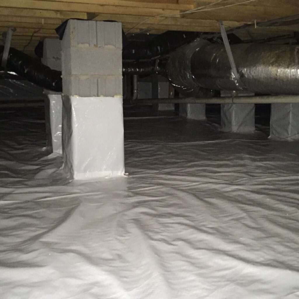 basement with white plastic encapsulation material installed on floor and around pier bases